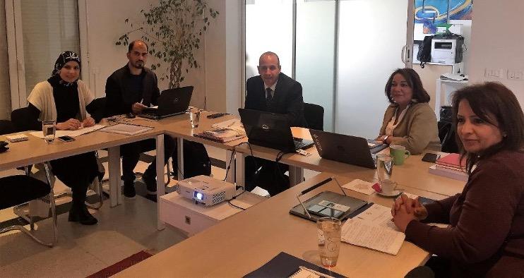 Representatives from Arab EMBs and the UNDP-Arab States Regional Electoral Assistance Project sitting around a table during a meeting organized by International IDEA in Tunis