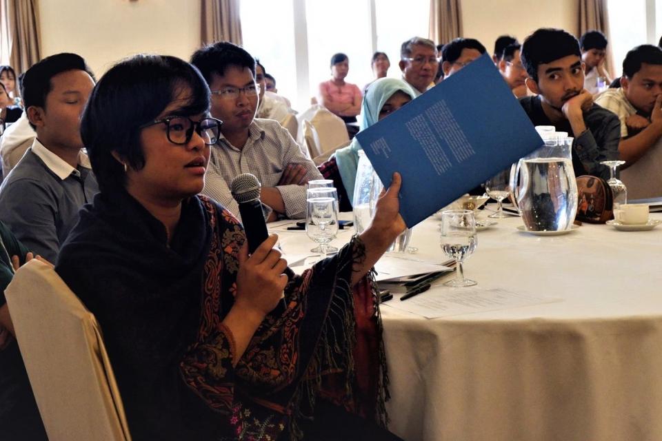 Young woman speaks during a meeting