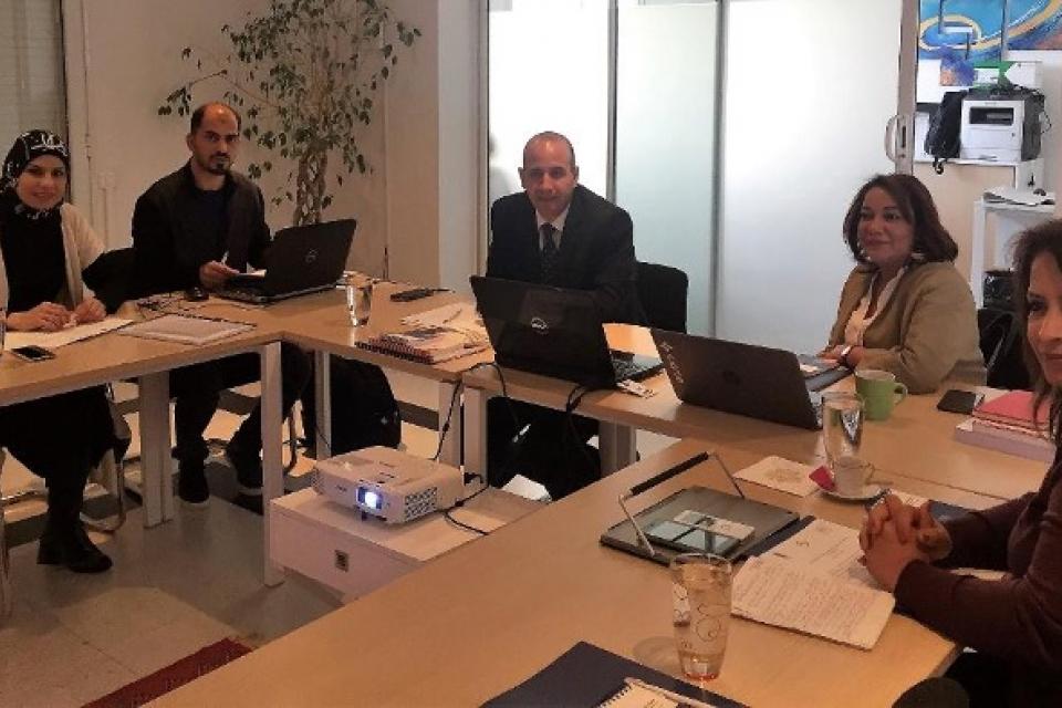 Representatives from Arab EMBs and the UNDP-Arab States Regional Electoral Assistance Project sitting around a table during a meeting organized by International IDEA in Tunis