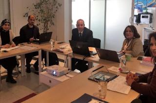 Representatives from Arab EMBs and the UNDP-Arab States Regional Electoral Assistance Project sitting around a table during a meeting organized by International IDEA in Tunis