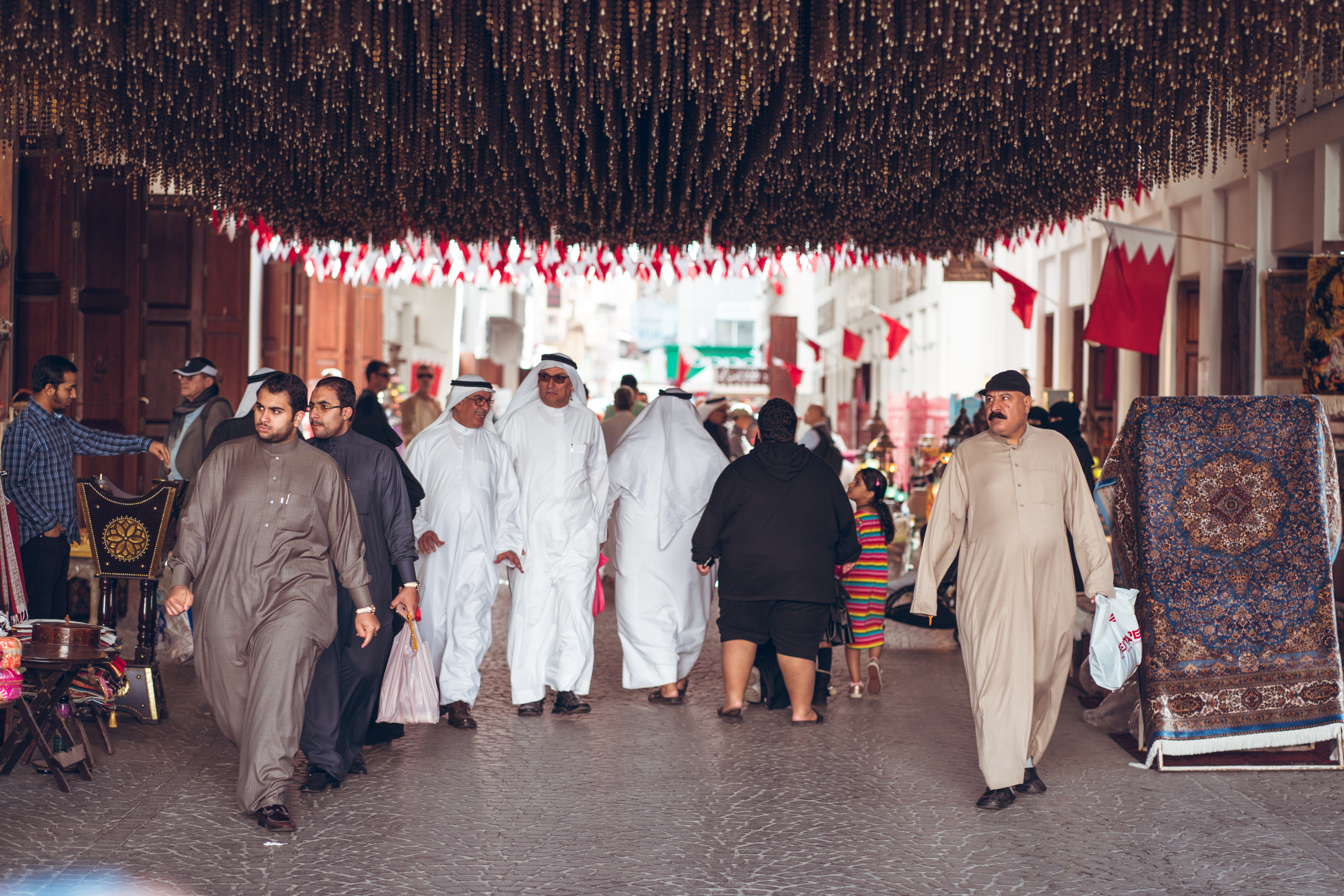 Local people wear traditional clothes shopping in Manama Souq, a famous tourist destination in the capital Bahrain Image Credit: Juan Alberto Casado via iStock Featured image