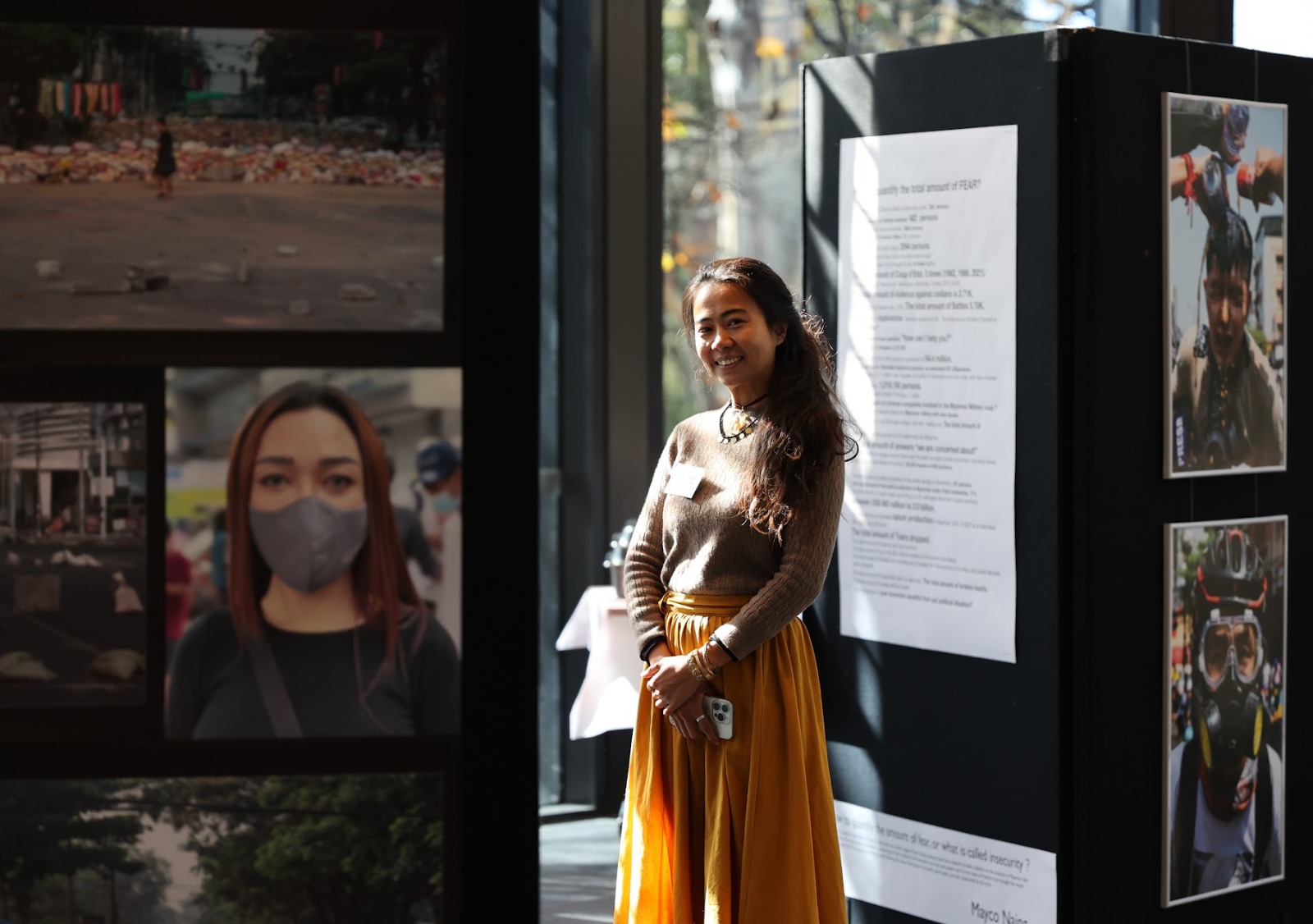 Photographer Mayco Naing at her ANU exhibition, “How to quantify FEAR