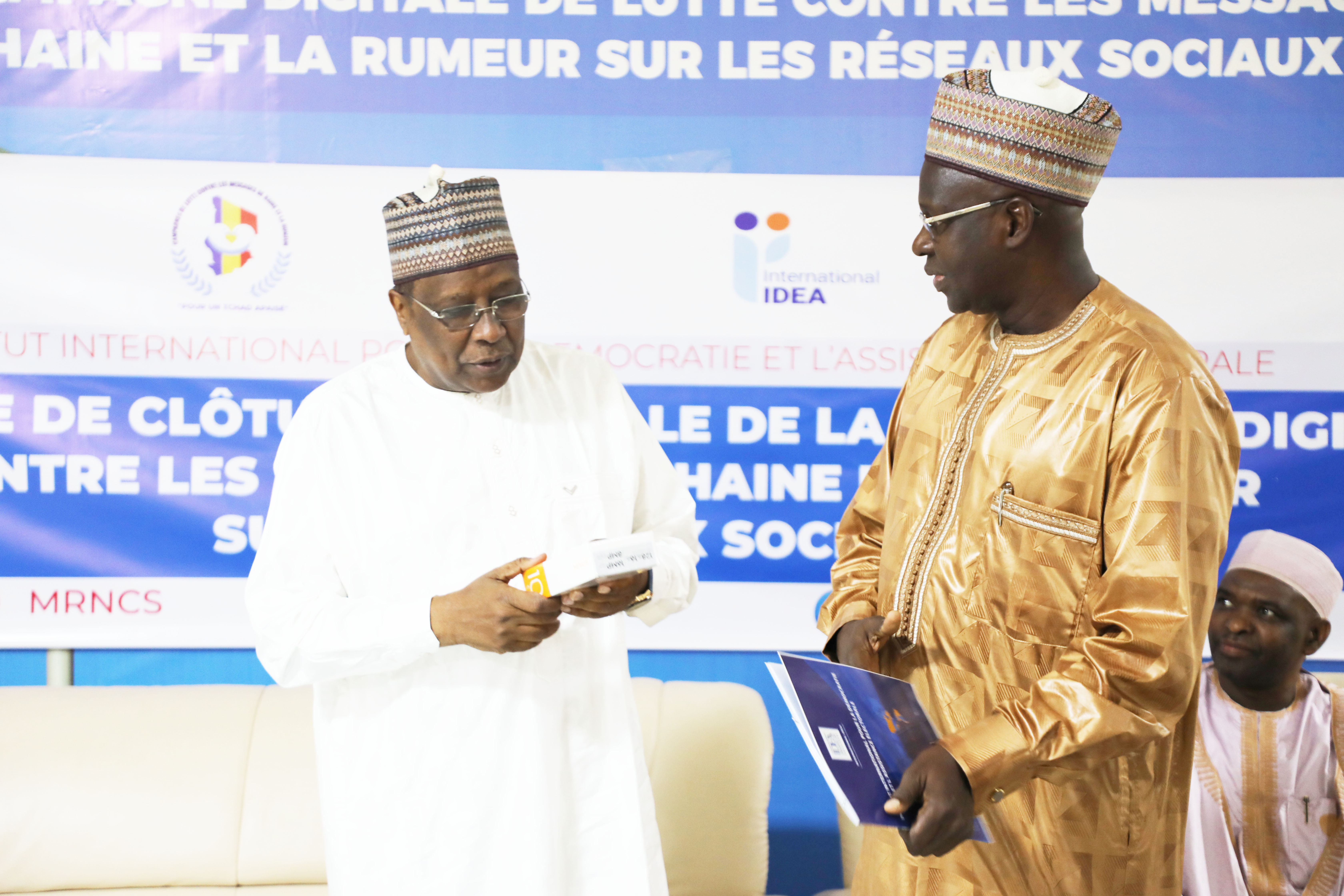 The IDEA International Chad Programme Manager symbolically handing over the campaign platforms to the Minister of National Reconciliation and Social Cohesion.