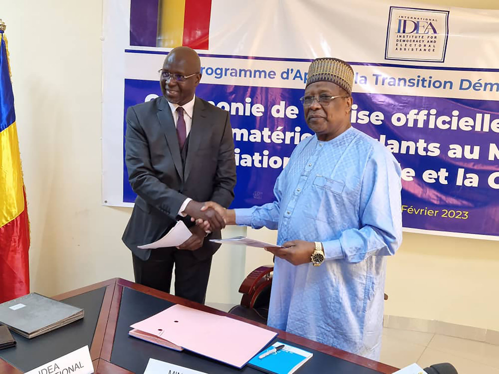 Handshake between the Minister for National Reconciliation and the Head of the International  IDEA Chad's Programme