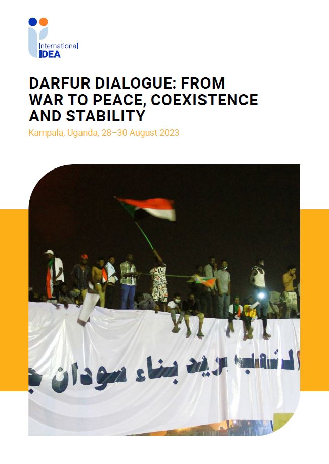 people sitting above a wall in Khartoum, Sudan, with a banner on the wall