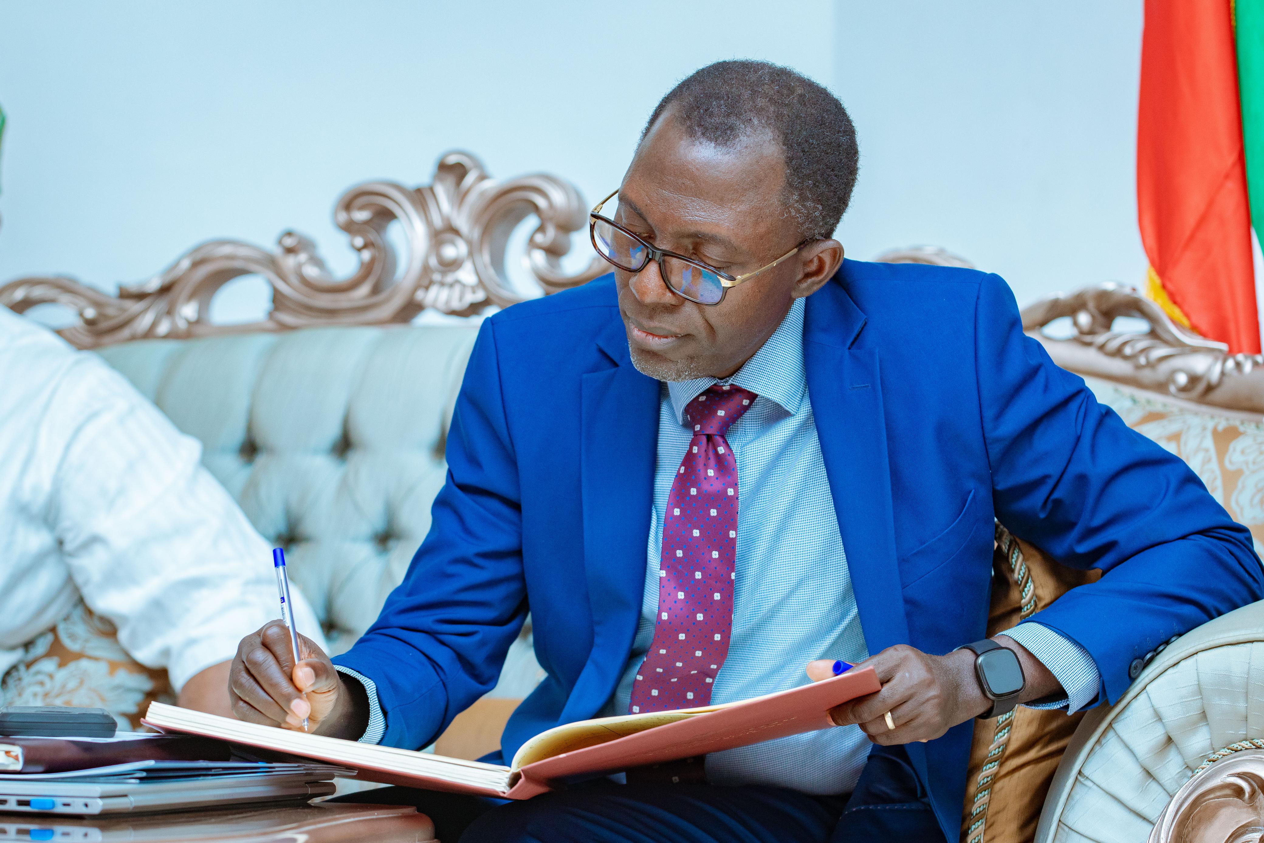 Mr Danladi Plang Signing the Governors Log Book 