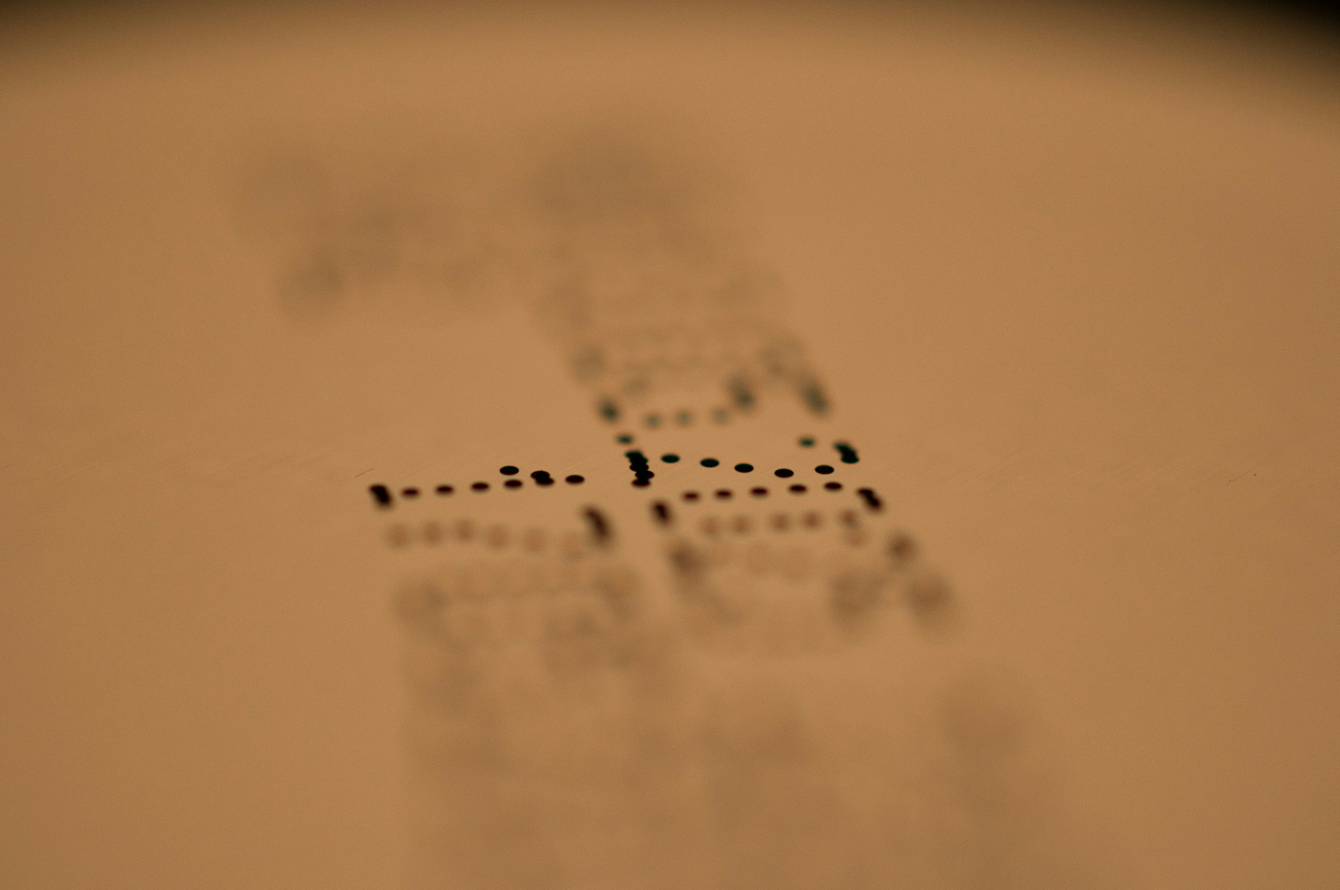 A dimly lit page with numbers on it, the picture is blurred toward the edges with the camera focusing on two numbers in the middle