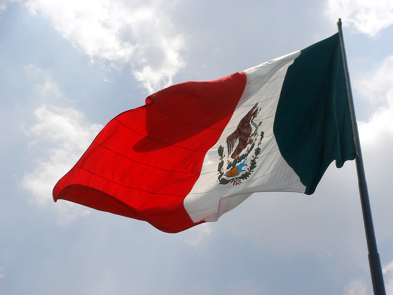La bandera mexicana ondeando sobre el Zócalo de la Ciudad de México. (<a href="https://flic.kr/p/2iFdu2" target="_blank">Photo</a>: Kevin Hutchinson / <a href="https://creativecommons.org/licenses/by/2.0/" target="_blank">CC BY 2.0</a>)