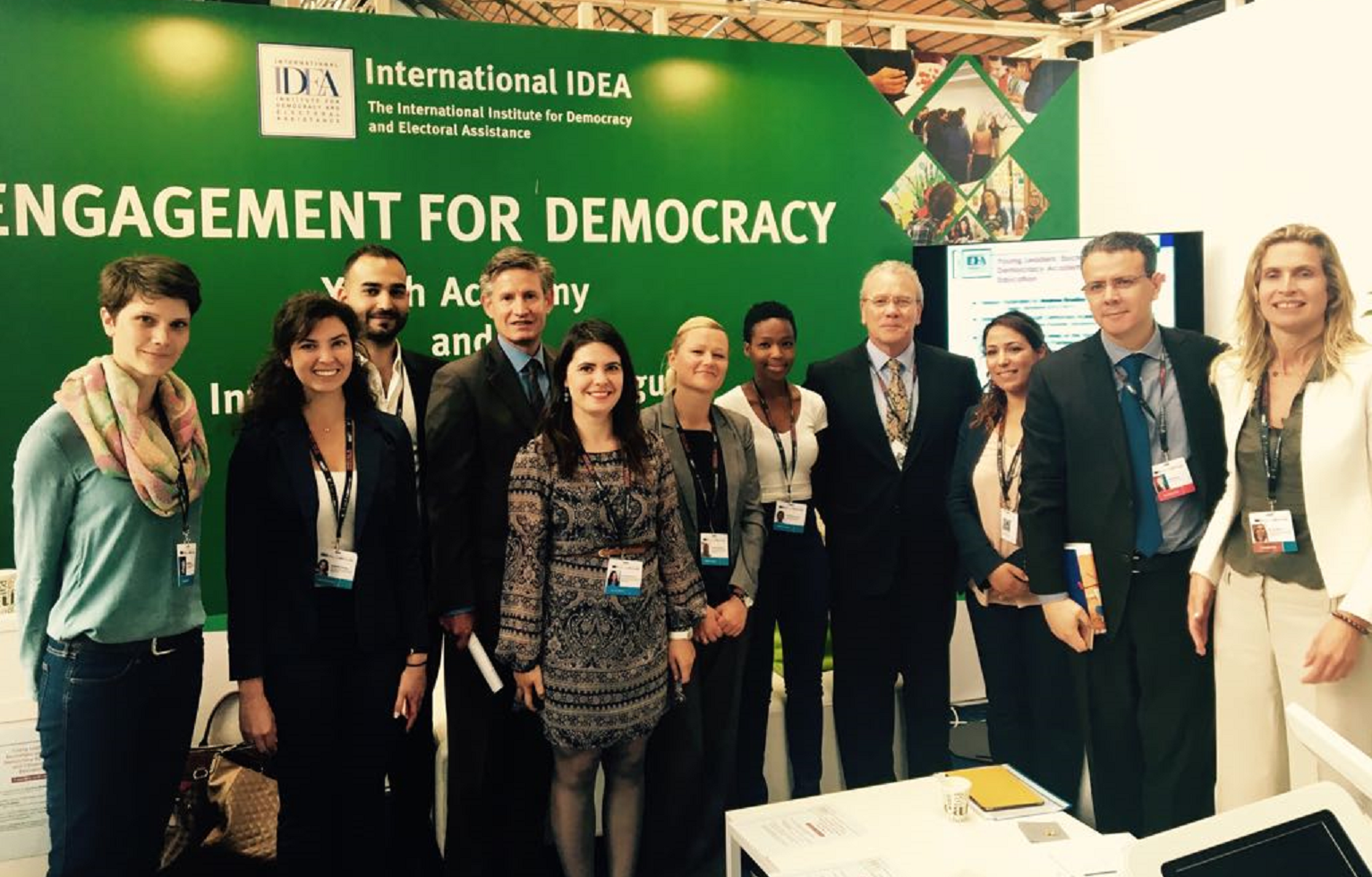 Opening ceremony of the International IDEA stand, group picture with International IDEA staff, H.E. Mr. Gonzalo Gutiérrez, Ambassador of Peru in Brussels, Mr. Hamed Zekri, Councellor at the Embassy of Tunisia in Brussels, and stand visitors.