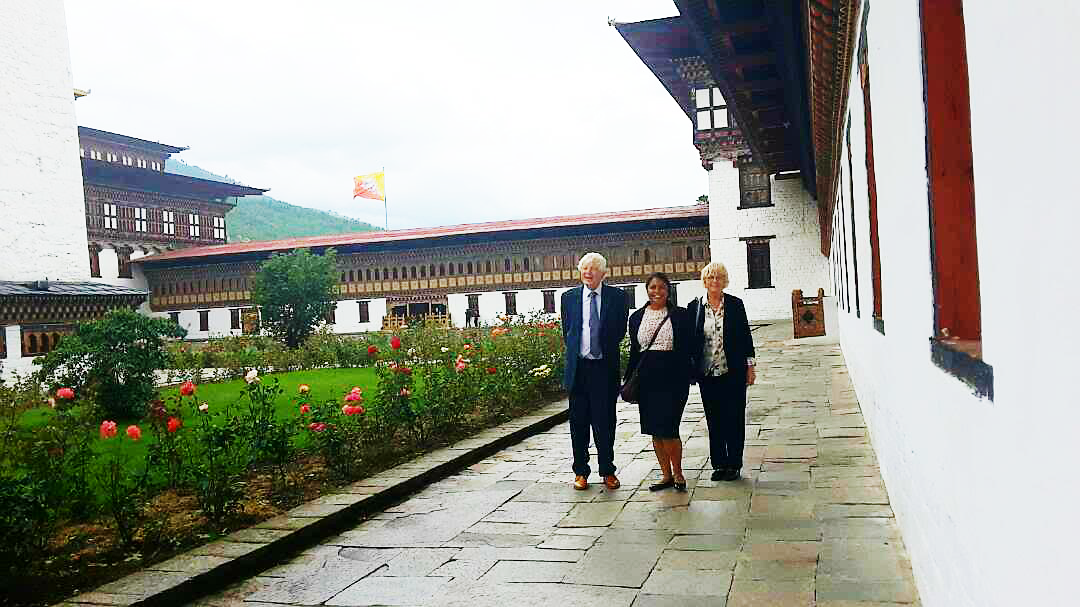 Lord Bryan Davies of Oldham, Ms Davies and Sinead Nicola Jayawickreme inside the Tashischho Dzong. Photo Credit: Pema Yangzome