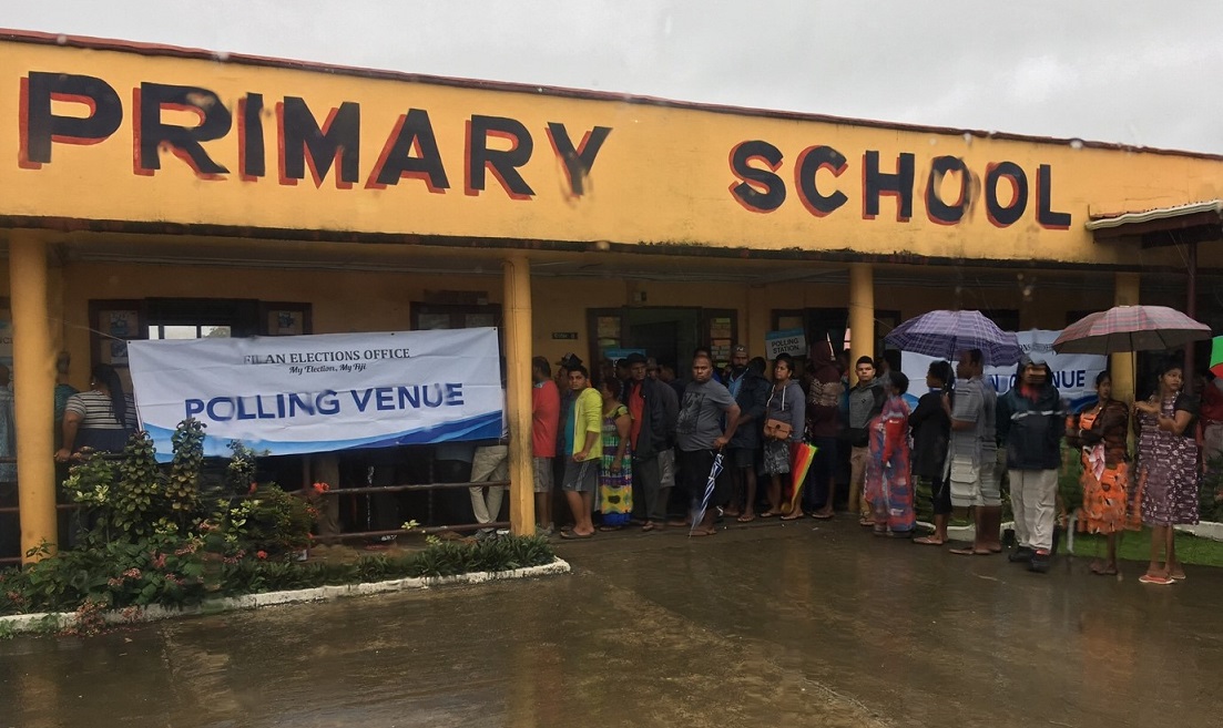 Voters queue to cast their ballots in Fiji early in the day, despite the rain. Image credit: Adhy Aman/International IDEA