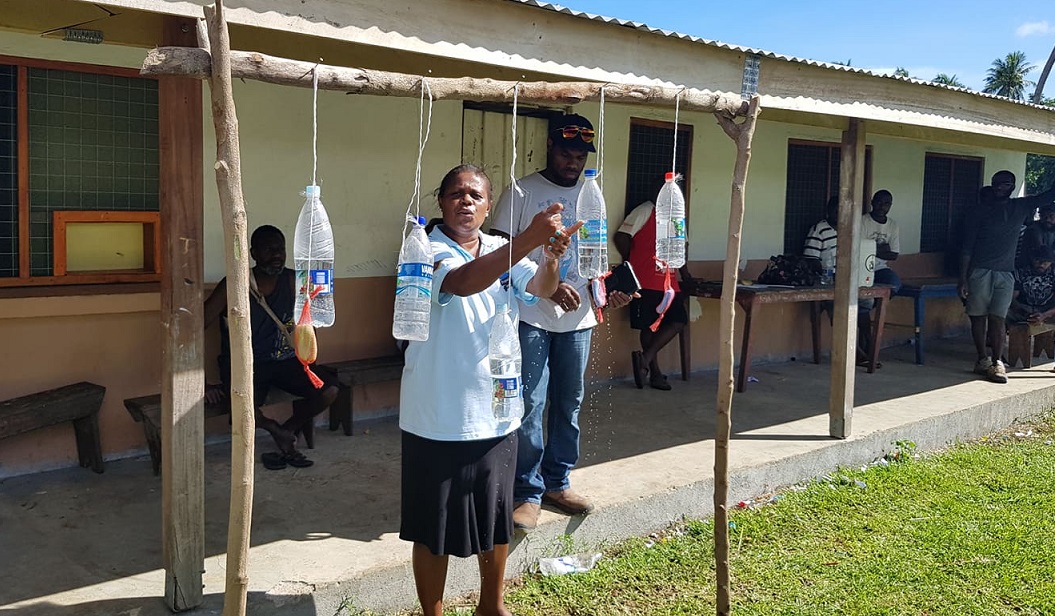 On the Election Day (19 March 2020) voters were made to wash their hands before casting ballots in a polling station on Malekula Island as a precaution against COVID-19. Health workers are seen working with election officials in explaining how the hand washing should be done. Image credit: the MSG Secretariat.