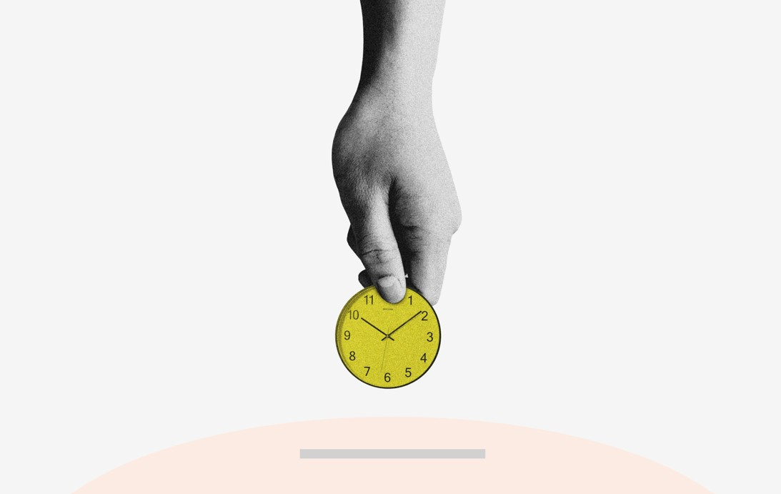a hand holding a coin to be put in a saving box