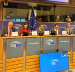 a number of staff in a panel during a conference