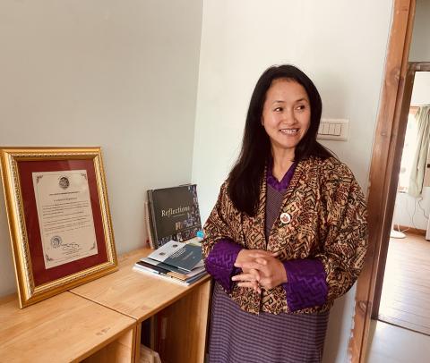 Tandin Wangmo, Executive Director of the Bhutan Centre for Media and Democracy (BCMD), displays BCMD's registration certificate. The organization was the first civil society organization in Bhutan to receive official registration.