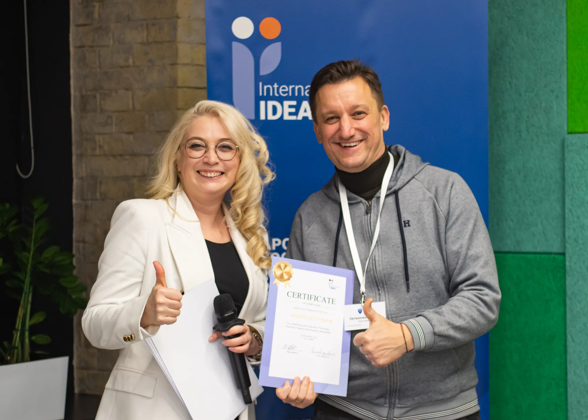 International IDEA Programme Manager Yuliya Shypilova (left) issues a certificate to the Deputy Head of the Department of Administration and Information Protection of the Secretariat of the Central Election Commission, Andrii Lytvyniuk, who participated in a capacity-building workshop on protecting elections in Ukraine, in Kyiv, Ukraine, November, 2024. Credit: Valeriia Landar