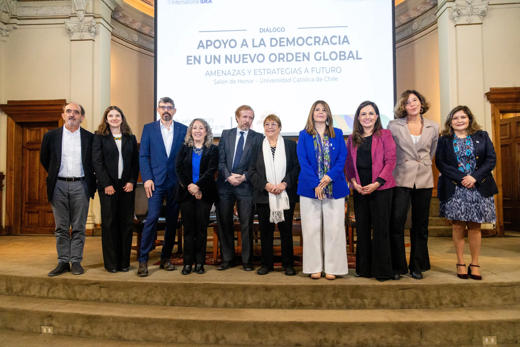 Autoridades de la Universidad Católica de Chile junto a Marcela Ríos Tobar, Directora Regional de IDEA Internacional y la Expresidenta Michelle Bachelet. Los acompañan autoridades y participantes del panel: Daniel Innerarity, Pablo Stefanoni, Daniela Campello y Alejandra Sepúlveda como moderadora.