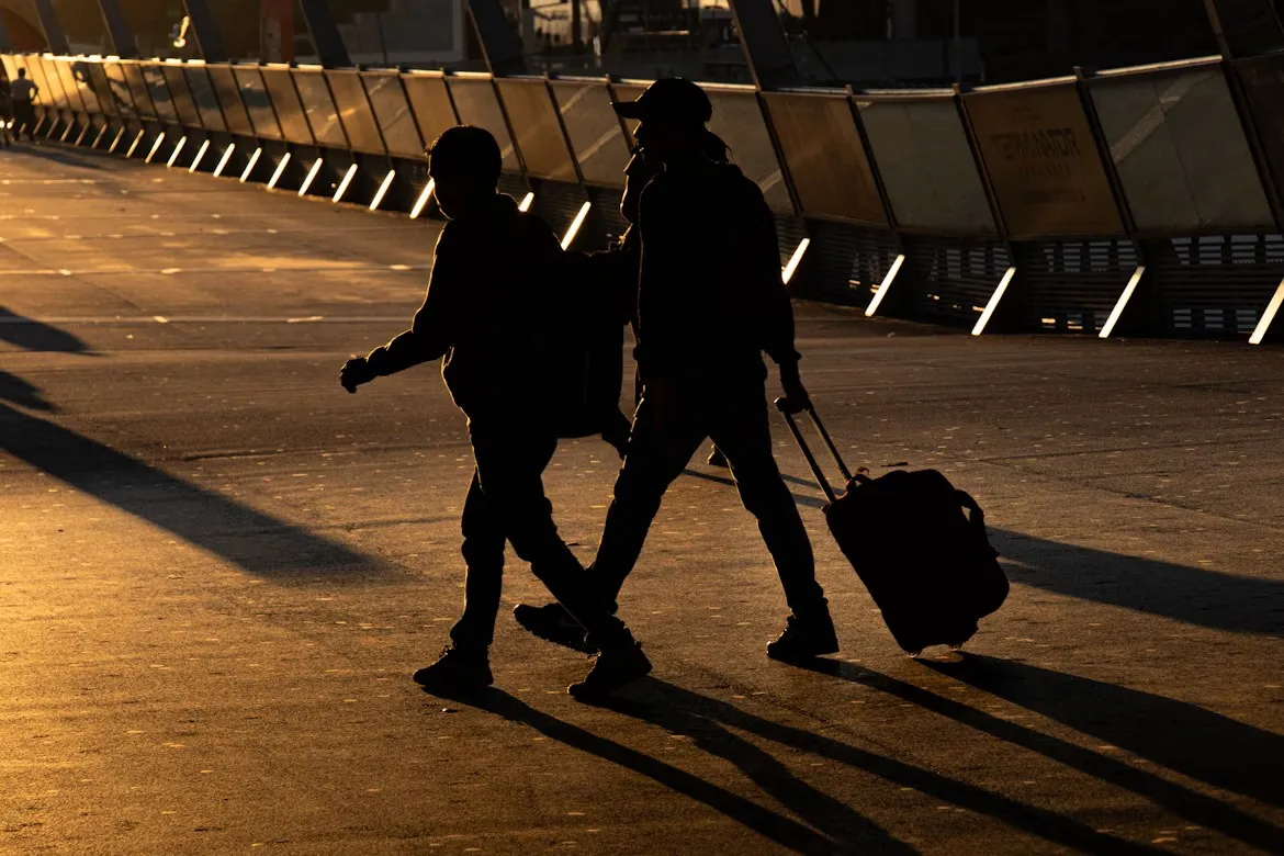 Two person walking on road in Melbourne, Australia. Image credit: Unplash, Mitchel Luo.
