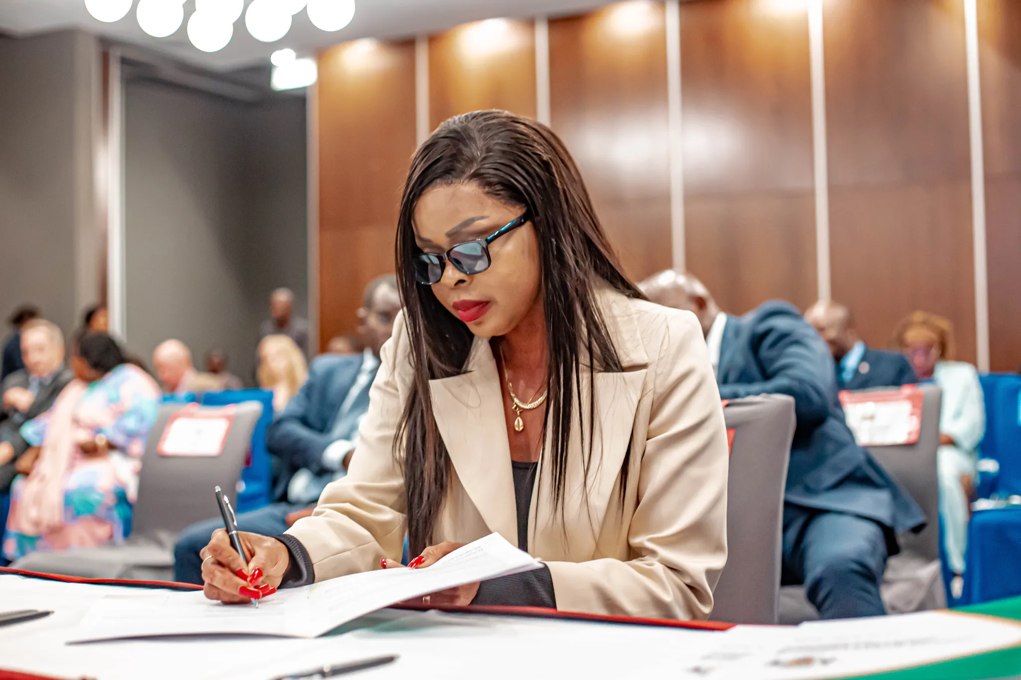 Gninga Chaning Zenaba, the only woman candidate to run in Gabon’s April 2025 presidential election, signs the voluntary code of conduct prior to the election. Libreville, Gabon, 27 March 2025. Credit: International IDEA