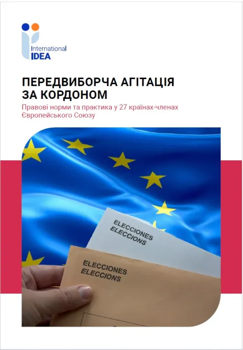 a person's hand holding two letters of mailing ballots with a background of the EU flag