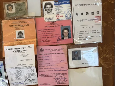 A collage of Larry Garber's Election Observer ID badges. 