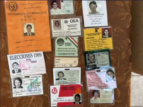 A collage of Larry Garber's Election Observer ID badges. 