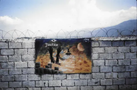 Depiction of arms breaking chains with the words Justice and Truth