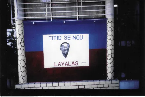 Portrait of Aristide with the words Aristide is Us and Lavalas