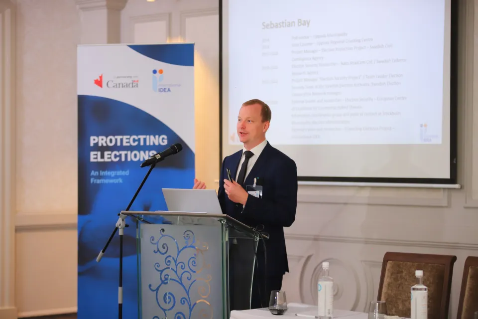 Election security expert Sebastian Bay opening remarks. Photo by Lume Production Company Ltd / International IDEA.