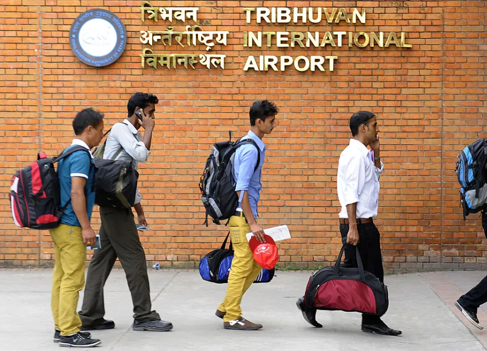 Nepalese migrant workers arrive at Tribhuvan International Airport in Kathmandu on 27 September 2013. Credit: PRAKASH MATHEMAAFP via Getty Images