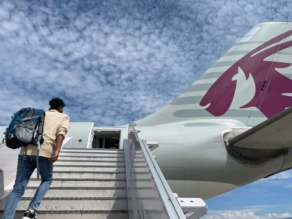 In this file photo, a Nepali migrant boards an outbound flight in 2025. (Credit: Upasana Khadka/MigrationLab