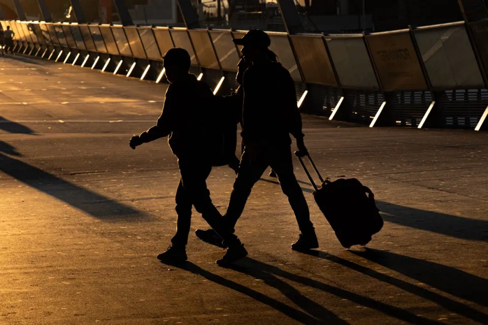 Two person walking on road in Melbourne, Australia. Image credit: Unplash, Mitchel Luo.