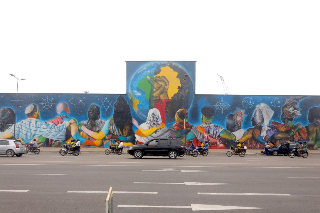 Africa's longest graffiti wall lines the perimeter of the Port of Cotonou — a mural of continental unity that echoes the layered, multipolar identities of those who move along the corridor: simultaneously local, national, and African. Credit: Manny Jefferson