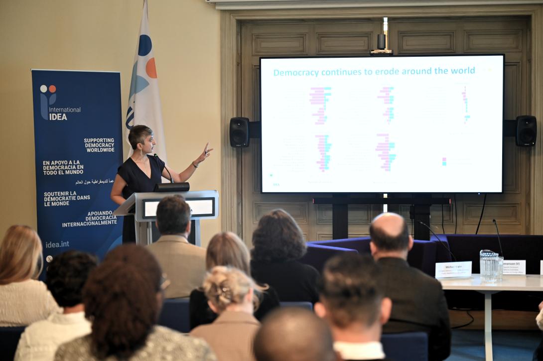 Dr Seema Shah, Head of Democracy Assessment at International IDEA, presenting on International IDEA's Global State of Democracy indices, situating Sweden within the broader global and regional trends